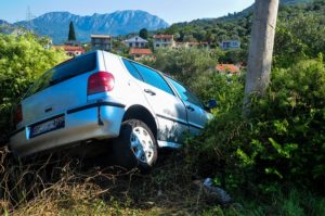 a car crashed into a pole on a hill