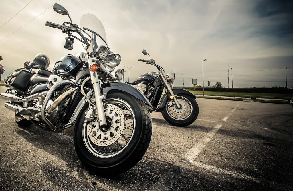 Two motorcycles parked in a parking lot