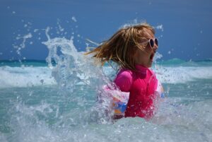 Little girl splashing in the ocean waves
