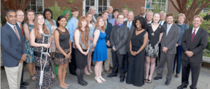 Group of people posing for picture outside