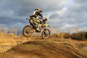 person riding a motorcyle on a dirt path