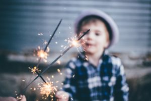 child holding sparklers