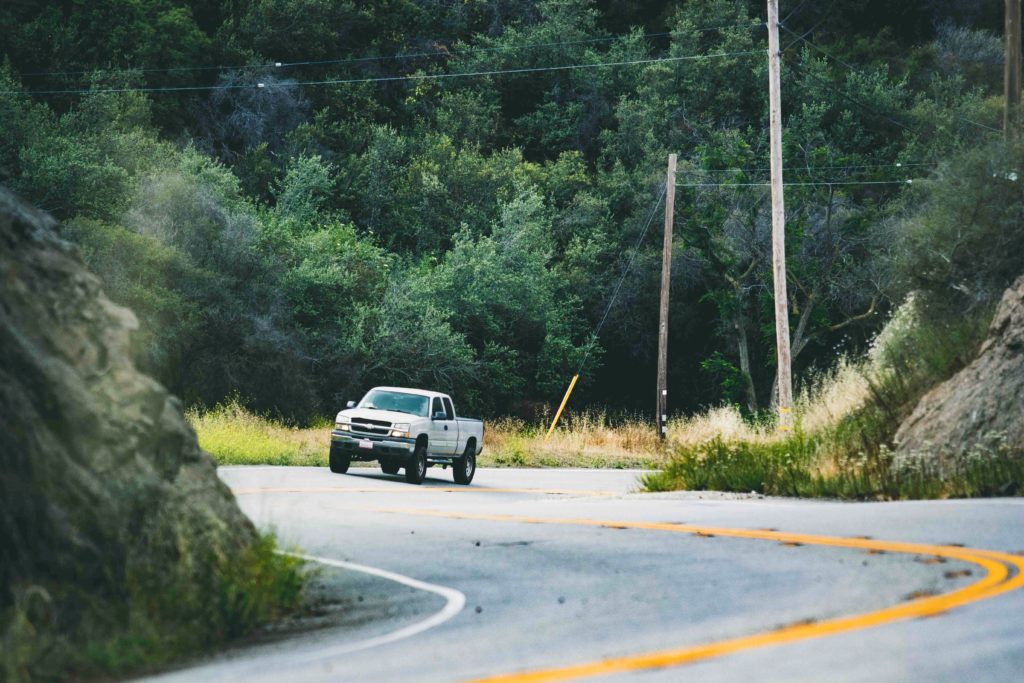 pick-up truck hugging a curve