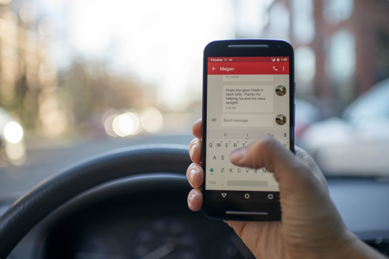 Person holding a phone while driving