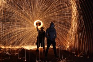 Men setting off champagne-colored fireworks