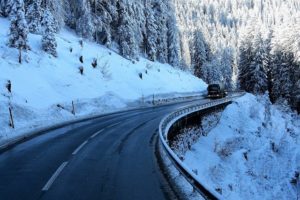 large truck driving up snowy mountain
