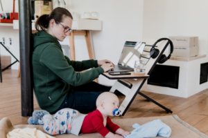 mom working from a home office with a baby