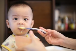baby being fed baby food