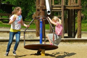 two young girls playing on a playground