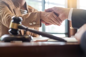attorneys shaking hands by a gavel