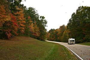 RV on a winding road in the fall