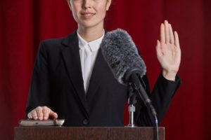 a woman testifying under oath in the courtroom