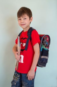 young boy wearing a backpack