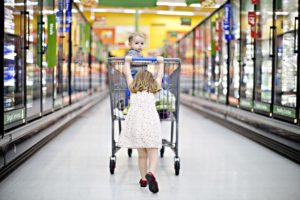 little girl pushing shopping cart