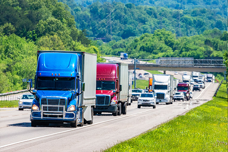 Traffic on highway composed of tractor trailers and cars
