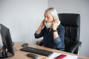 woman at work in neck brace