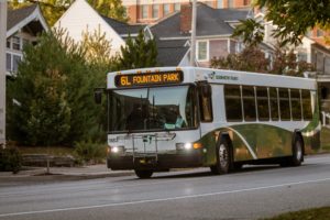 a bus traveling through a neighborhood