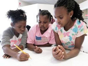 three black girls studying together