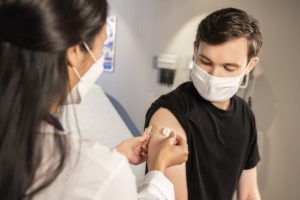 man getting covid vaccine