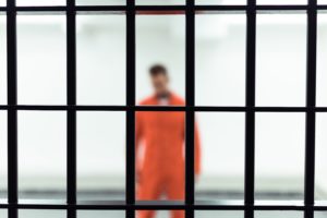 rapist behind bars in jail