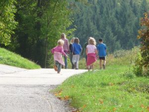 children running through a park