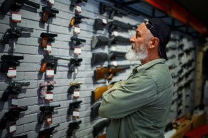 man shopping for guns