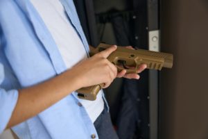 teenager picking up a gun