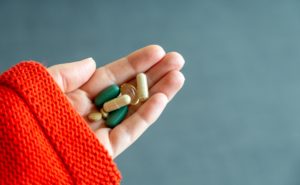 Hand holding variety of pills