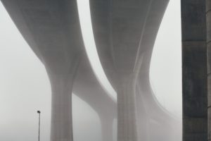 fog obscuring a highway bridge