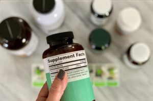 woman reading label on health supplements