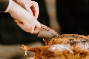 person carving turkey