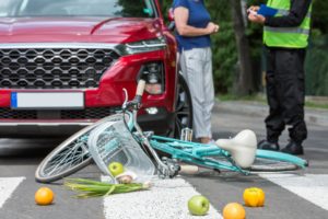 pedestrian struck on bike, with spilled produce on the street