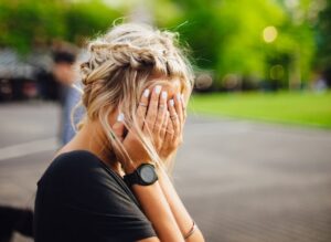 sad woman of sexual assault covering her face