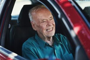 elderly man driving slowly