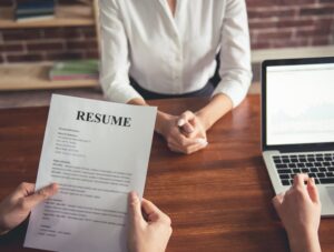 woman handing a resume over for reading
