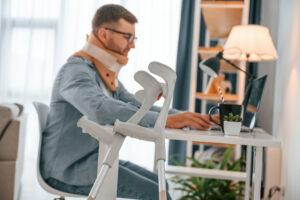 man in neck brace applying for jobs