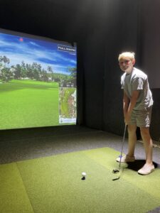 Griffin McMillan playing virtual golf