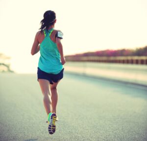 woman running along the side of the road