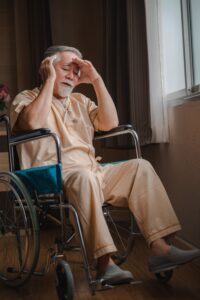 depressed elder in a nursing home sitting in a wheelchair