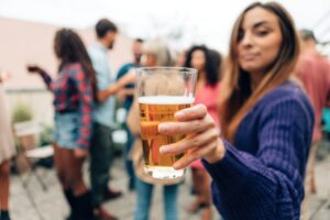 woman holding a beer at a party