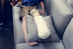Kid with a scalding burn recovering on a couch
