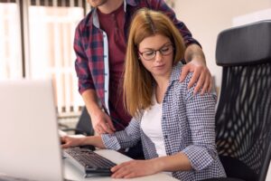 Woman being sexually harassed at work