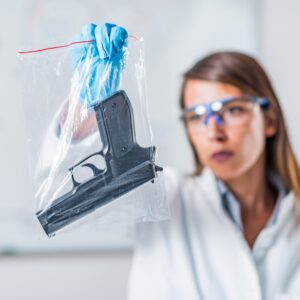 Investigator holding a gun as evidence