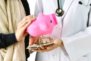 couple emptying a piggy bank to pay for medical bills