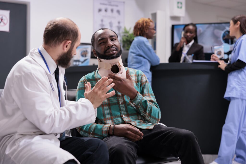 injured person in a neck brace talking to a doctor injured person in a neck brace talking to a doctor