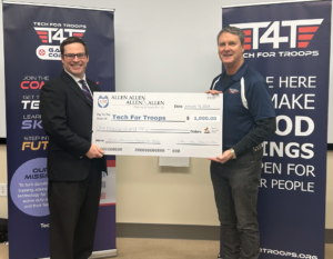 Attorney Bradley Kent (pictured left) presents a check to Mark Casper