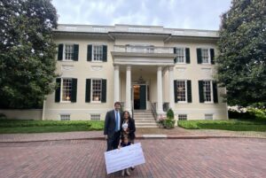 Yamamato's daughter holds the check in front of the Executive Mansion