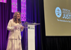 Bridget Long addresses the Women Trial Lawyers Caucus