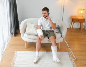 Man in a cast thinking about filing a personal injury claim