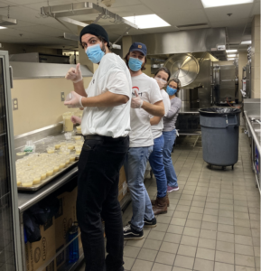 The Giving Heart volunteers cooking dinner